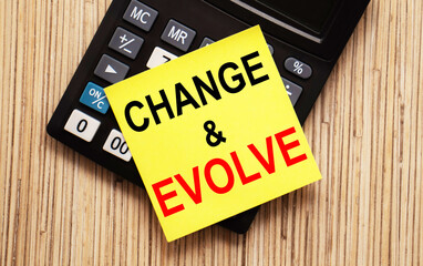 calculator with text CHANGE EVOLVE with yellow paper