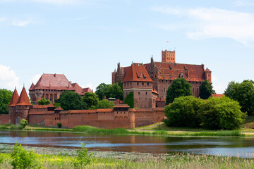 Naklejka na ściany i meble Malbork, Poland - June 25, 2020: 13th century Malbork Castle, medieval Teutonic fortress on the Nogat River. It is the largest castle in the world, UNESCO World Heritage Site