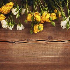 Beautiful Roses Bouquet. Yellow and white Flowers on wooden Background. Place for text, flat lay, top view, copy space