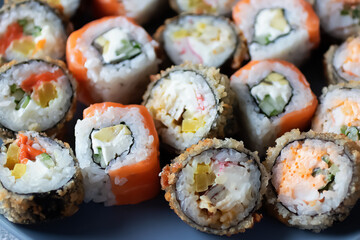 Assorted sushi on a gray plate. Close-up.
