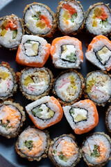 Assorted sushi on a gray plate. Close-up.