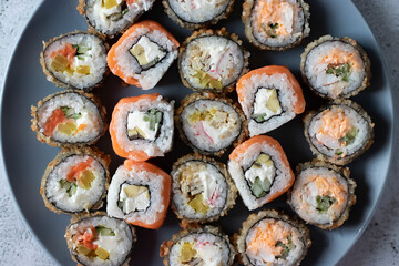 Assorted sushi on a gray plate. Close-up.