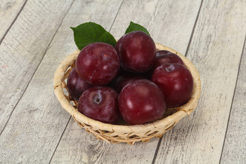 Plum heap in the wooden basket