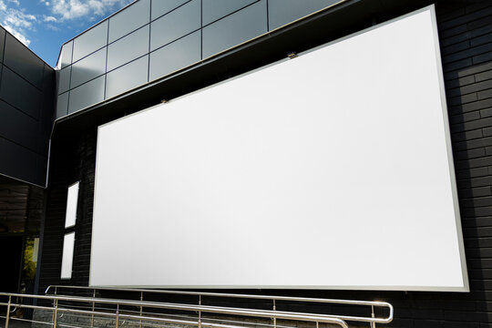 Mock Up Billboard On The Black Wall Of A Large Building