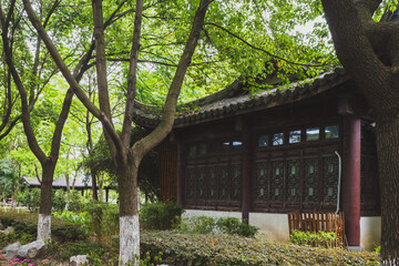 Fototapeta na wymiar Traditional Chinese house between trees in South Lake scenic area in Jiaxing, China