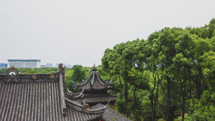 Fototapeta na wymiar Traditional Chinese architecture of Wuxiang Temple by trees in South Lake scenic area in Jiaxing, China
