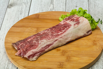 Raw beef bacon over wooden board