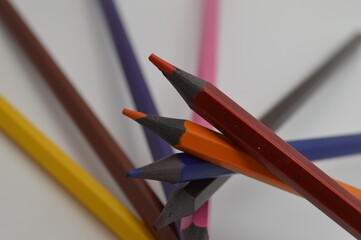 Colored wooden pencils on a white background
