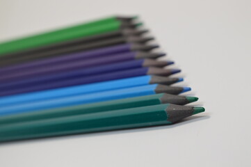 Naklejka premium Colored wooden pencils on a white background