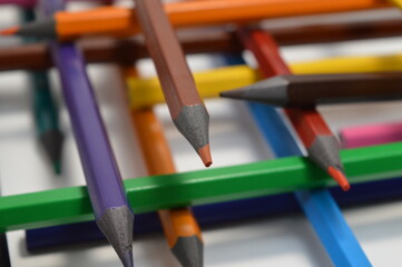 Colored wooden pencils on a white background