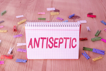Handwriting text writing Antiseptic. Conceptual photo antimicrobial agents that delays or completely eliminate the microorganism Colored clothespin papers empty reminder wooden floor background office