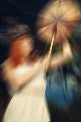 beautiful shamanic girl playing on shaman frame drum in the nature, movement effect.