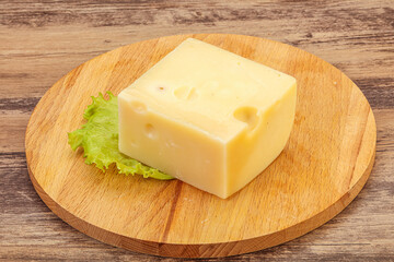 Emmental cheese over wooden board