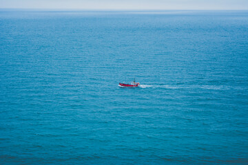 Red Boat at Sea