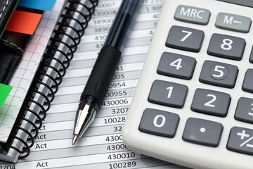 business office desk closeup - financial reports, analysis and accounting, set of documents, tables and graphs, various items for bookkeeping, calculator