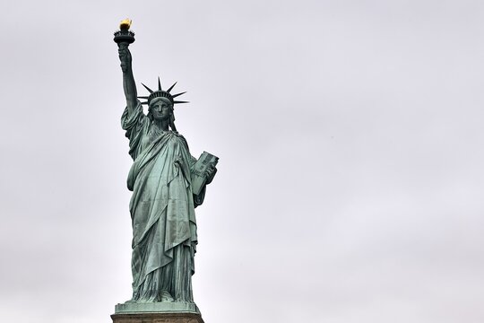 Low angle shot of the amazing Statue of Liberty in New York, USA - Powered by Adobe
