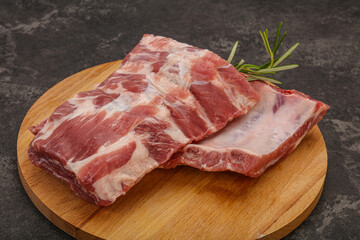 Raw pork ribs served rosemary