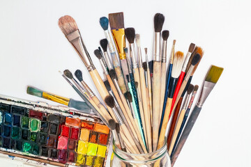 Set of artist accessories collection.Art brushes of various sizes, watercolors on a white...