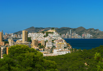 Obraz premium Panorama of the Benidorm city resort and Tossal de la cala from a hill of a natural park in Villajoyosa. Costa Blanca. Spain