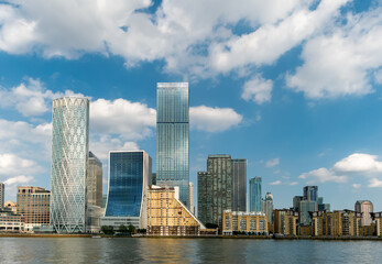 Tall modern buildings of Canary Wharf area of London on the riverside of Thames