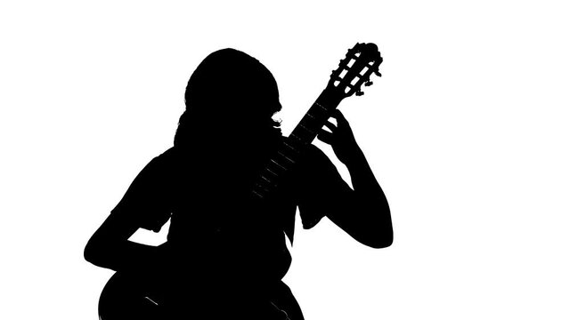 black silhouette on a white background, pretty girl playing the classical acoustic guitar. Medium long shot