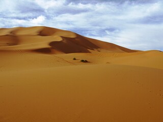 Sand dunes of Erg Chebbi under blue skywith white clouds, Morocco
