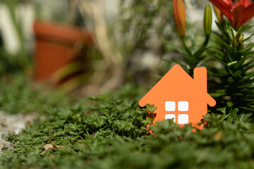 imply flat lay design with miniature white toy house