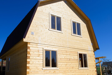 A wooden house under construction. Stage of build of a two-storey residential building.