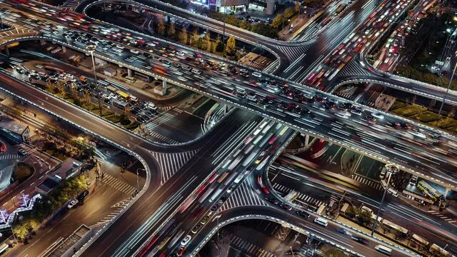TL/ZO Asia, China, Beijing, Aerial view Zoom Out Time lapse of busy road intersection in Beijing's financial district, with  traffic and commuters during evening rush hour