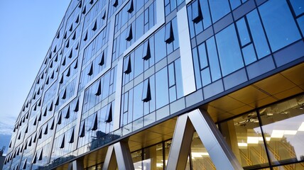 Facade texture of a glass mirrored office building. Fragment of the facade. Modern architecture of the office building. © Grand Warszawski
