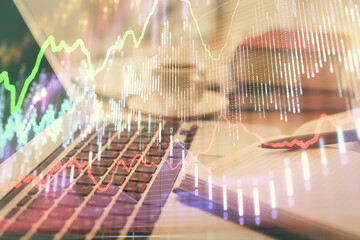 Double exposure of financial chart drawing and desktop with coffee and items on table background....