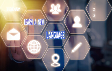 Handwriting text Learn A New Language. Conceptual photo ability to communicate in the second orforeign language Grids and different set up of the icons latest digital technology concept