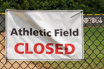 Sign on a Baseball field indicating that it is closed due to Covid 19