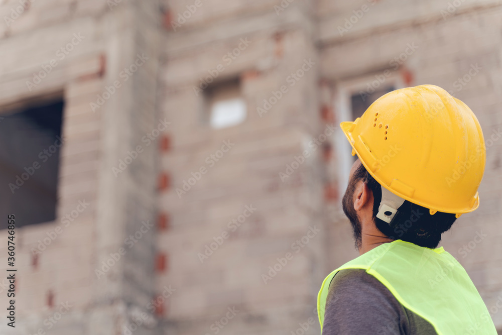 Wall mural young man architect on a building construction site