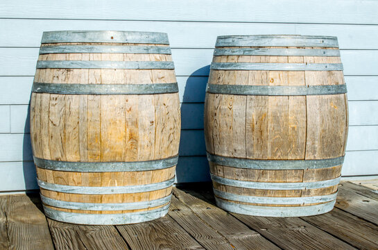 two vintage wooden barrels outside a brewery