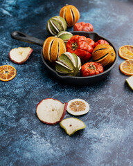 Beautiful food portrait of Wnter seasonal dried fruits with old vintage texture background and cutlery and accessories