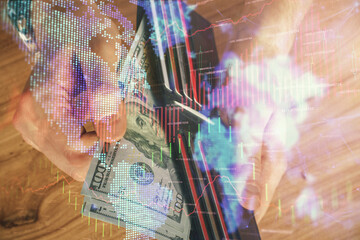 Multi exposure of forex graph drawing hologram and USA dollars bills and man hands. Technical Analysis concept.