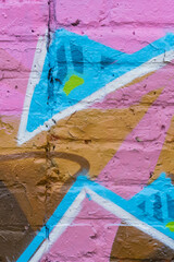 Generic crop of a graffiti style bright painted background on a brick wall.