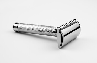 Chrome double-edged classic shaving safety razor shot in a white studio.