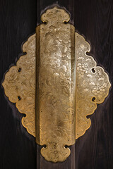 Decorative gold pattern on the door hinge at the Higashi-Honganji Temple, Kyoto, Japan.