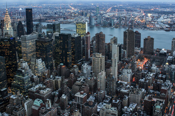 Fototapeta na wymiar Illuminated New York skyline with skyscrapers seen from an aerial view
