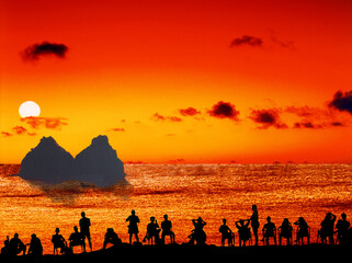 Tourists watching the sunset in Fernando de Noronha island.