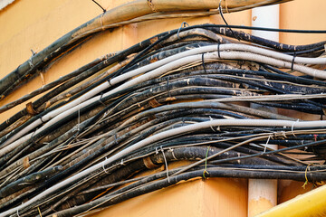 Numerous electrical wires on the facade of the building