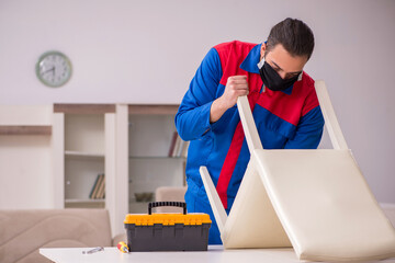 Young carpenter working indoors during pandemic disease