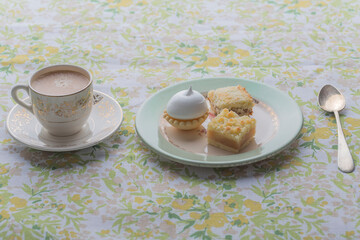Breakfast with coffe and delicious petit cakes