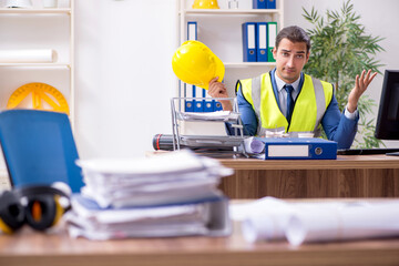 Young male architect working in the office