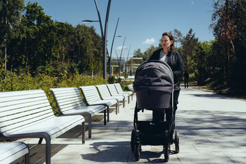 Woman enjoying her time off on the coastline of the Baltic sea. Leisure time of a mother with her...