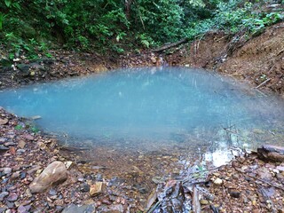 A small turquoise pool in the natural forest of Thailand.