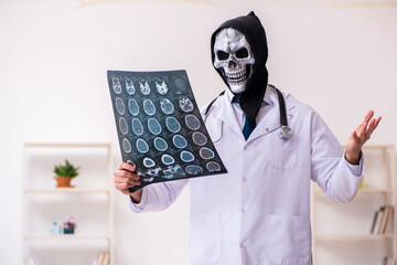 Male devil doctor radiologist working in the clinic