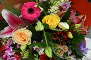 Colorful bouquet of various flowers including yellow roses